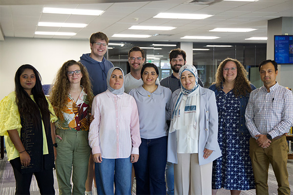The 10 new faculty members pose for a group photo in the Karl Mundt Library.